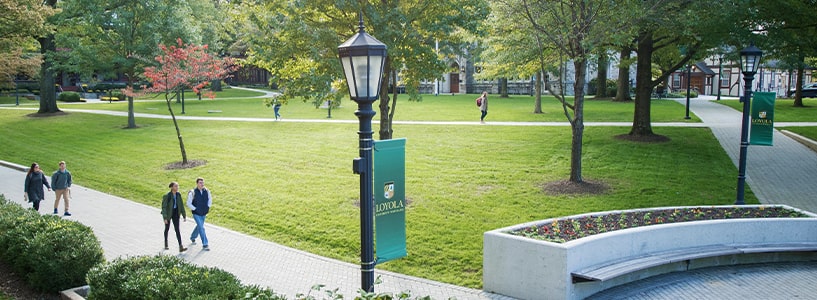 Students walk along various pathways on Loyola's Quad