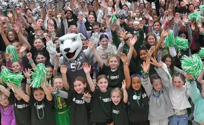 The Loyola mascot and a large group of girls cheering