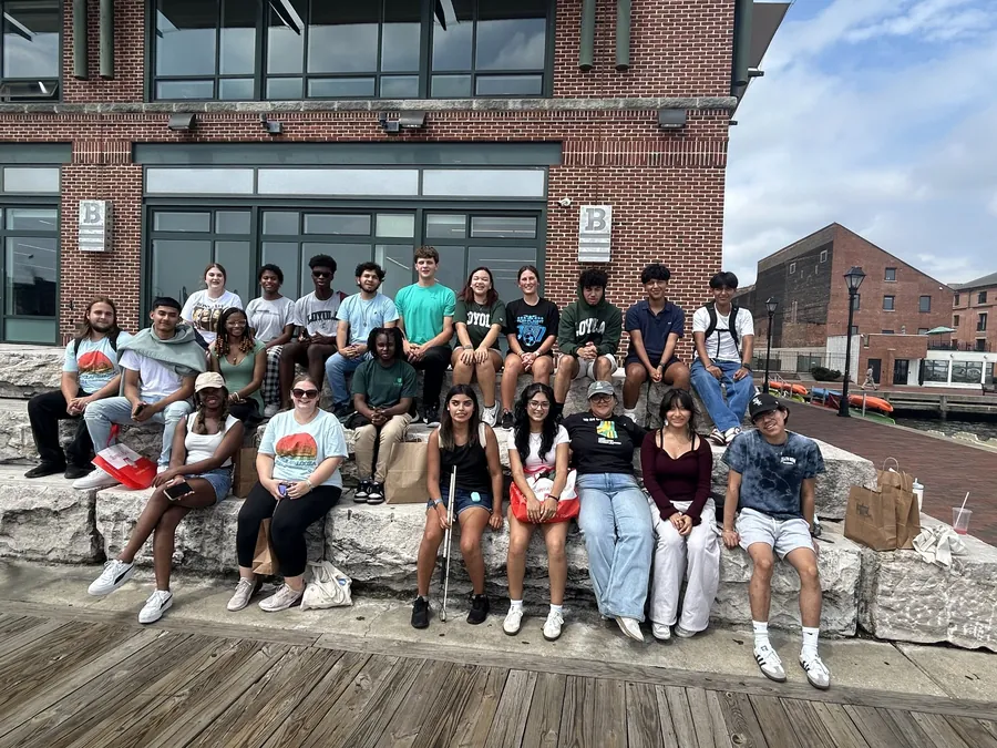 First-Generation college students sit on stone benches in downtown Baltimore