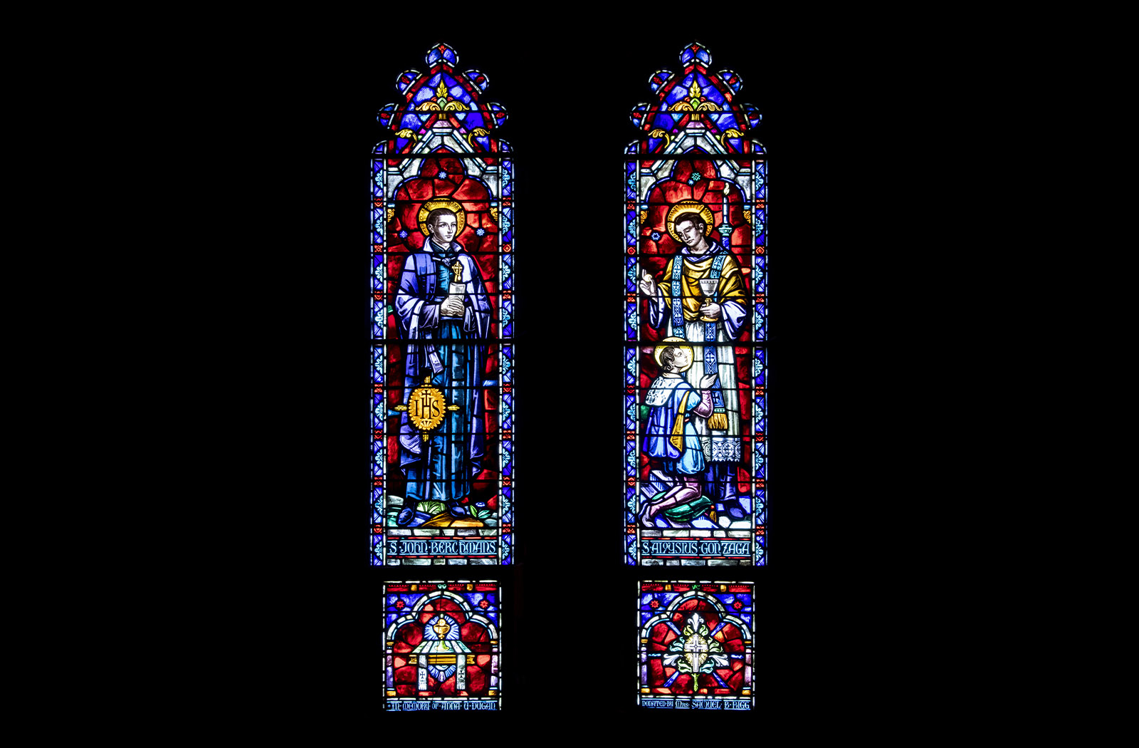 Two colorful stained glass panels of St. John Berchmans and St. Aloysius Gonzaga