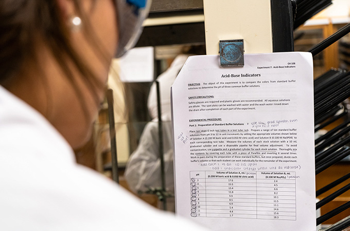 A student reads the assigned lab report.
