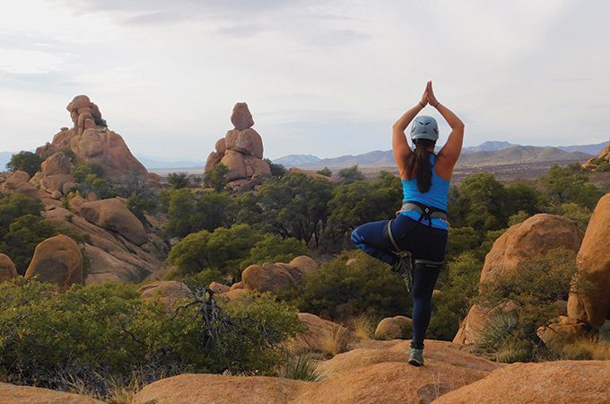 Morning yoga in front of a rocky landscape.