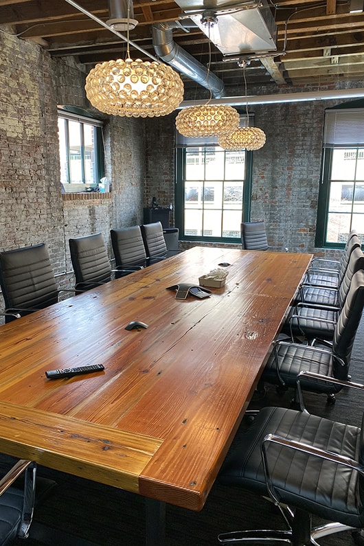 Photo of a long conference table and chairs in a modern office in downtown Baltimore