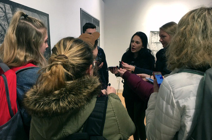 Media students interviewing a student inside an art gallery