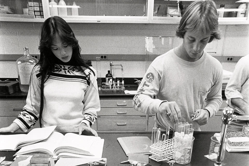Vintage black and white photo of two students working in a lab in Donnelly Science Center