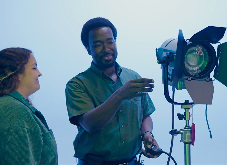 Jay Dunmore and April Hartman working with a studio light