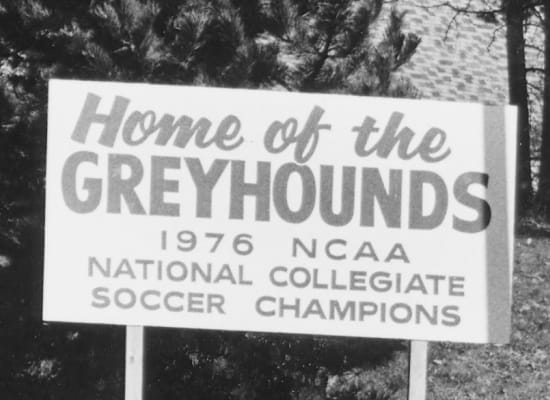 Sign from the 70s that reads: Home of the Greyhounds. 1976 NCAA National Collegiate Soccer Champions