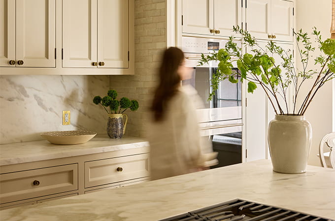 Model walking through a kitchen.
