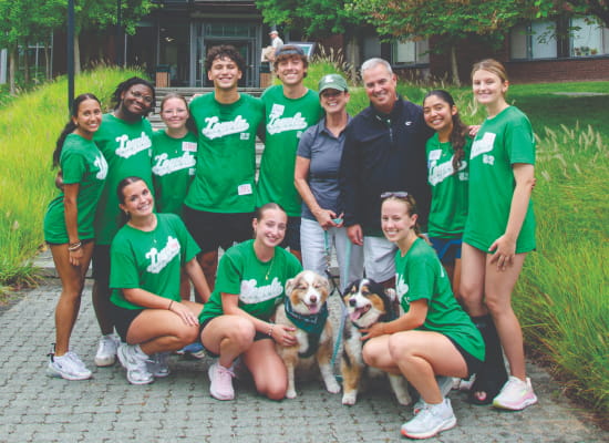 A group picture of President Terrence M. Sawyer, J.D., his wife, Courtney Sawyer, M.S. ’93, and Loyola students