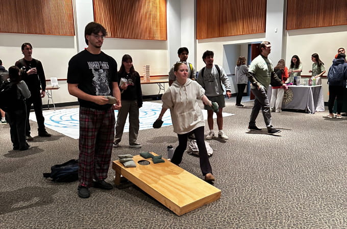 Students at Wellfest playing cornhole