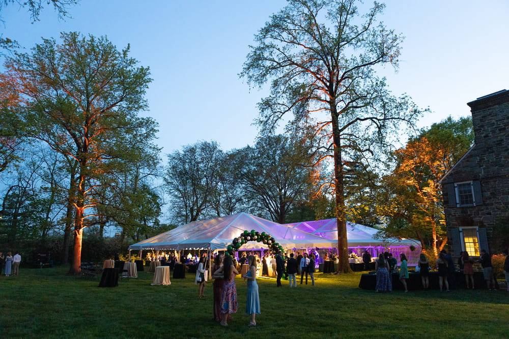 Loyola seniors gather under a decorated tent on the President’s lawn during Senior Soiree, an evening celebration before Commencement.