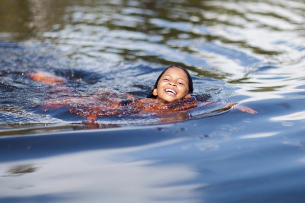 child swimming in a river