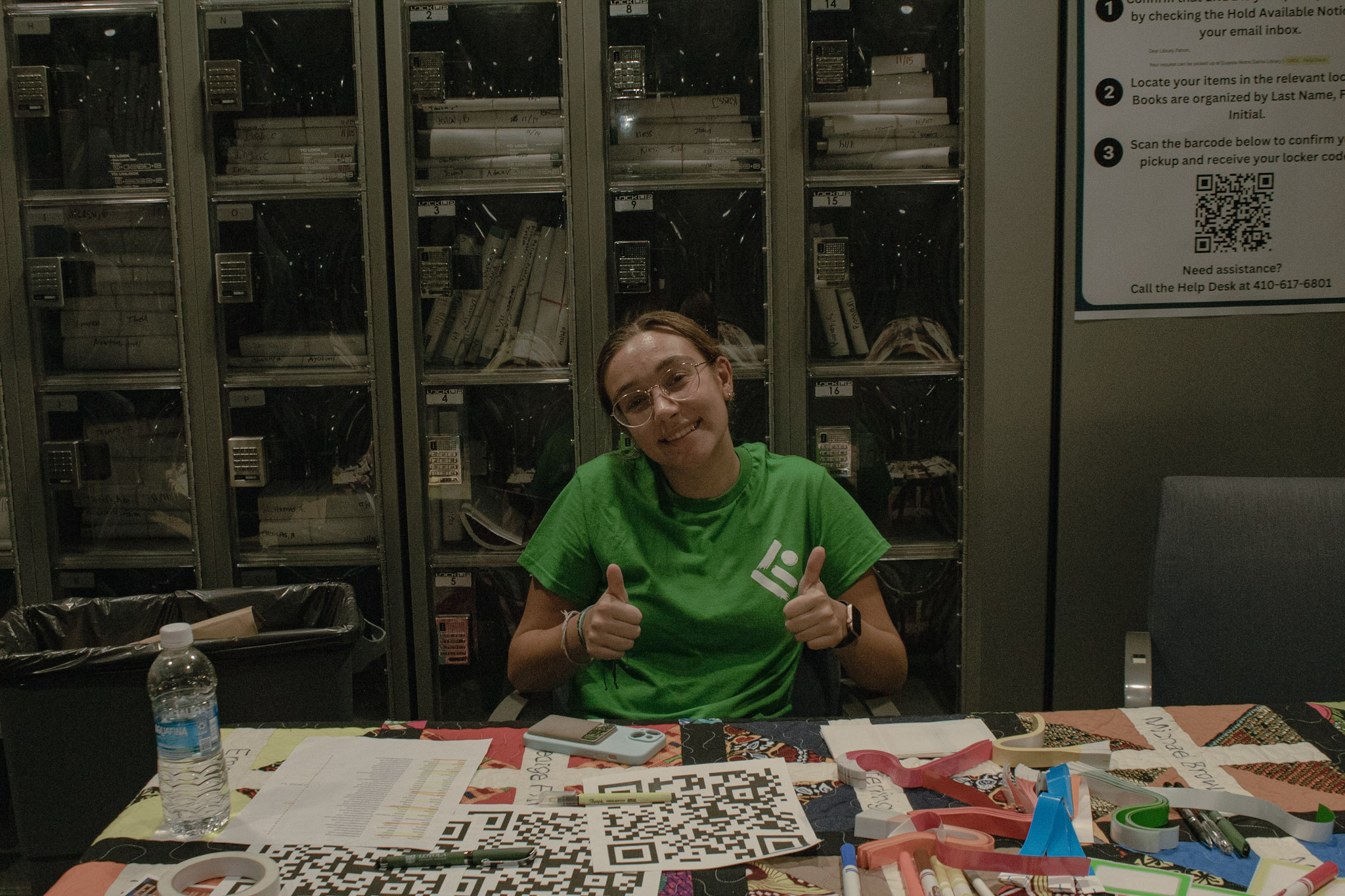 Samantha Vitale, journalist and social media intern for the Karson, sits behind a check-in table welcoming guests to the Karson Institute's 4th year anniversary