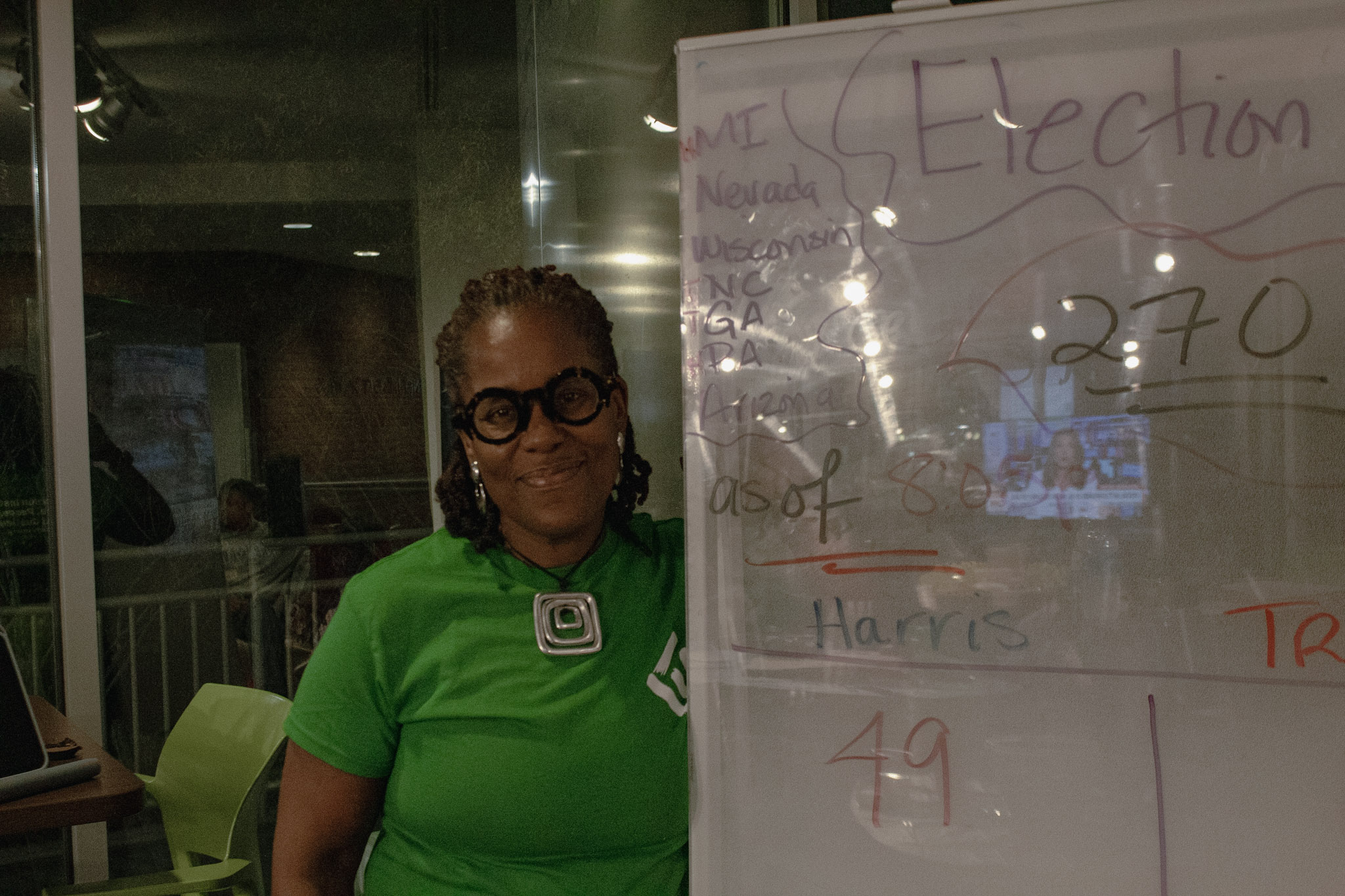 Dr. Karsonya "Kaye" Wise Whitehead Ph.D. stands next to a board showing a running tally of electoral college votes