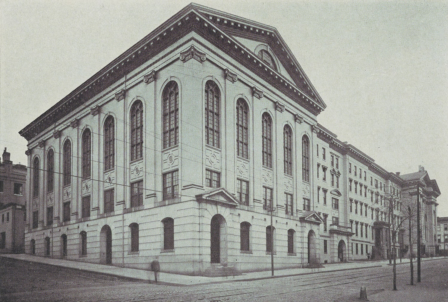 Black and white drawing of a large stone building with windows.