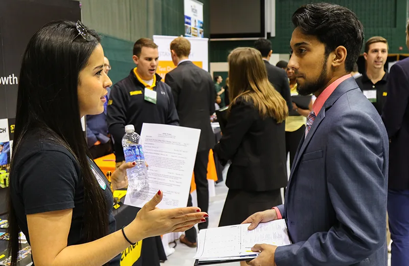 A student talks with a recruiter during a career fair