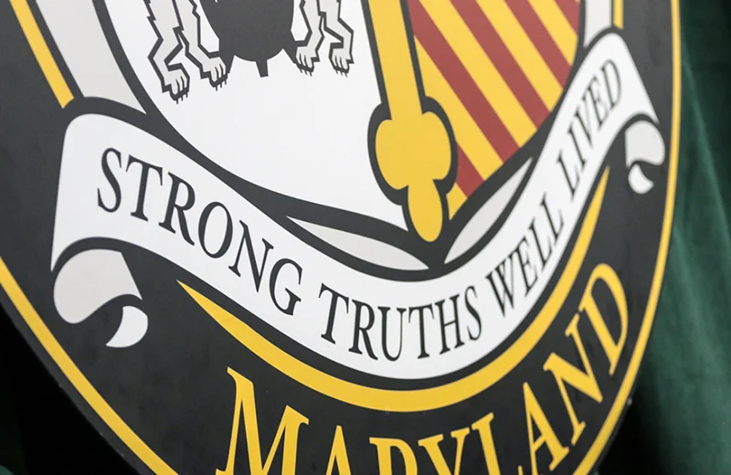 The Loyola shield, showing the text Strong Truths Well Lived
