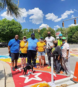 York Road Initiative volunteers pictured on crosswalk art installation along York Road