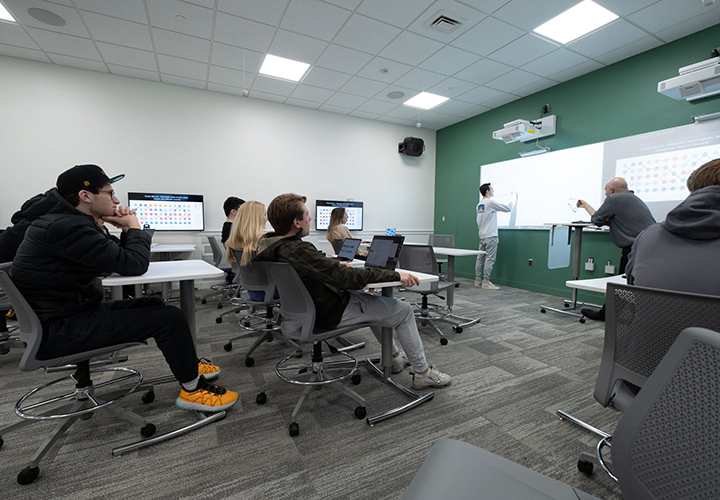 Students participate in class discussion in the Sellinger's new data visualization lab