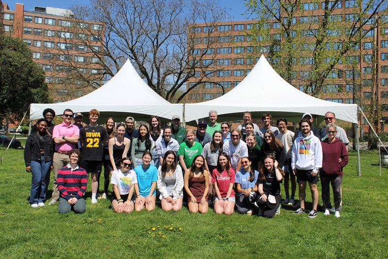 Student volunteers who provided free tax help pose for a photo under a tent outside on Loyola's Evergreen campus.