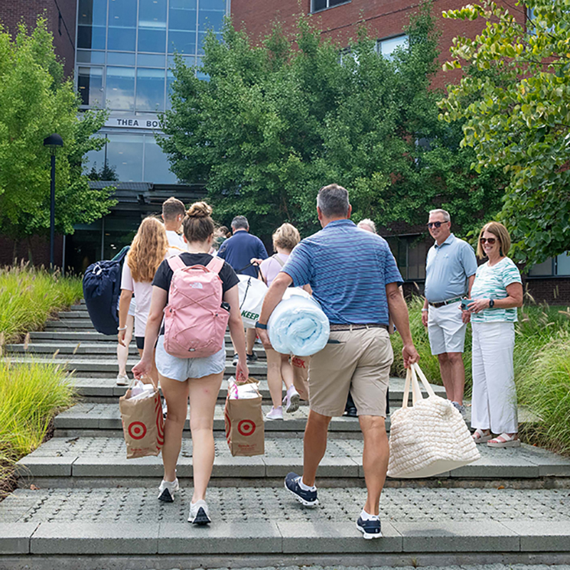 President Sawyer and his wife, Courtney, greet families outside of Thea Bowman Hall as first year students move in.