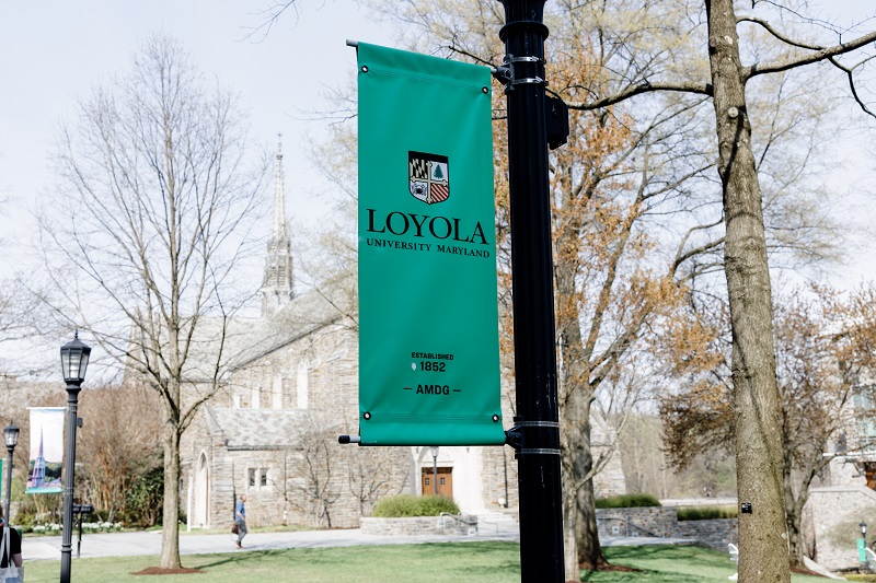 A green Loyola banner is displayed on the University's campus