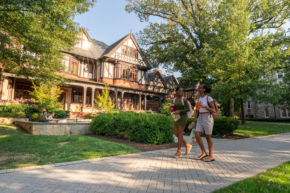 Two Loyola students walk in front of the Humanities building