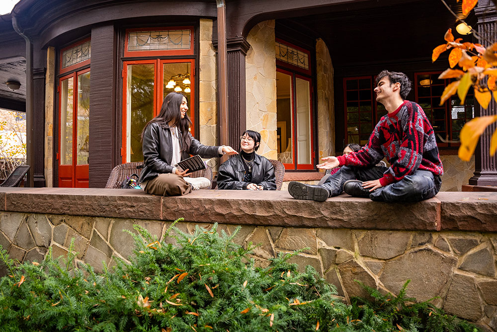 Students on the porch of Loyola's Humanities Building