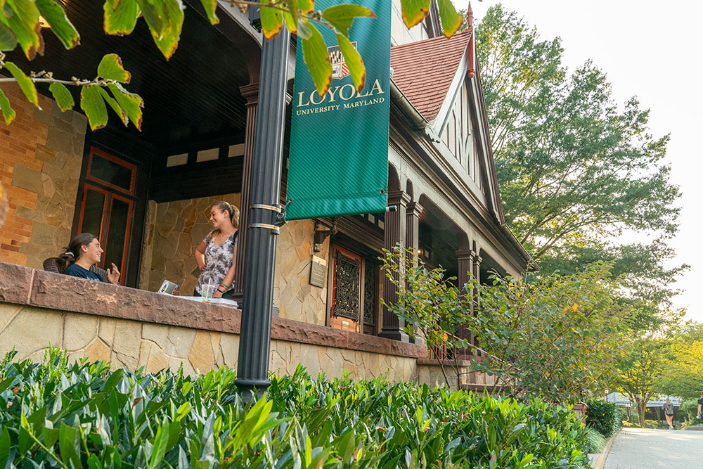 Students on the porch of Loyola University Maryland