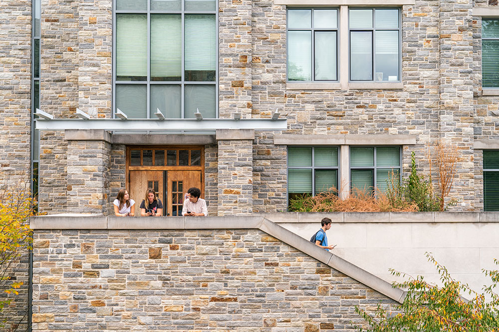 Students talking on the steps of Loyola's Sellinger School