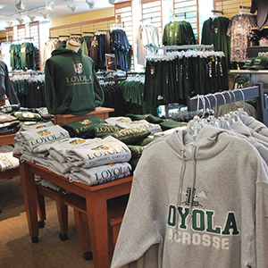Loyola sweatshirts and t-shirts hanging in the Loyola Bookstore