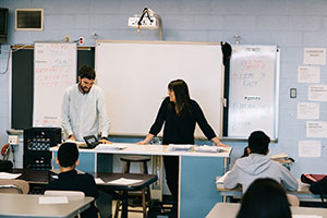 Intern and teacher at front of class teaching