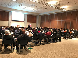 Photo of attendees sitting and listening to Jerry Weast