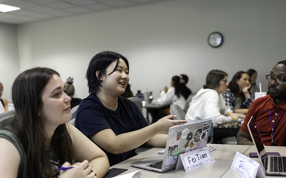 Graduate students discussing educational technology