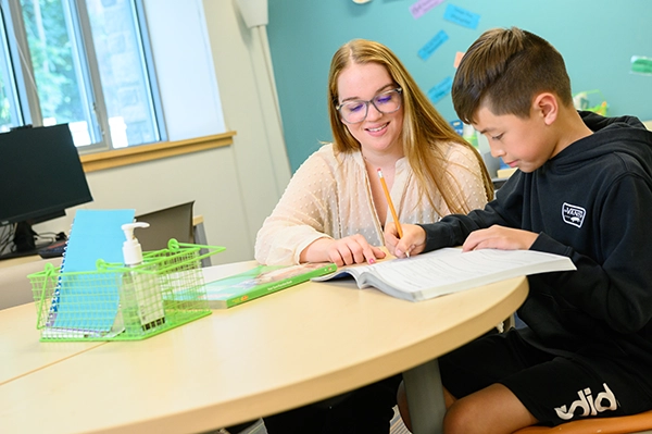 teacher working with student