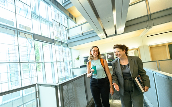 student walking with professor